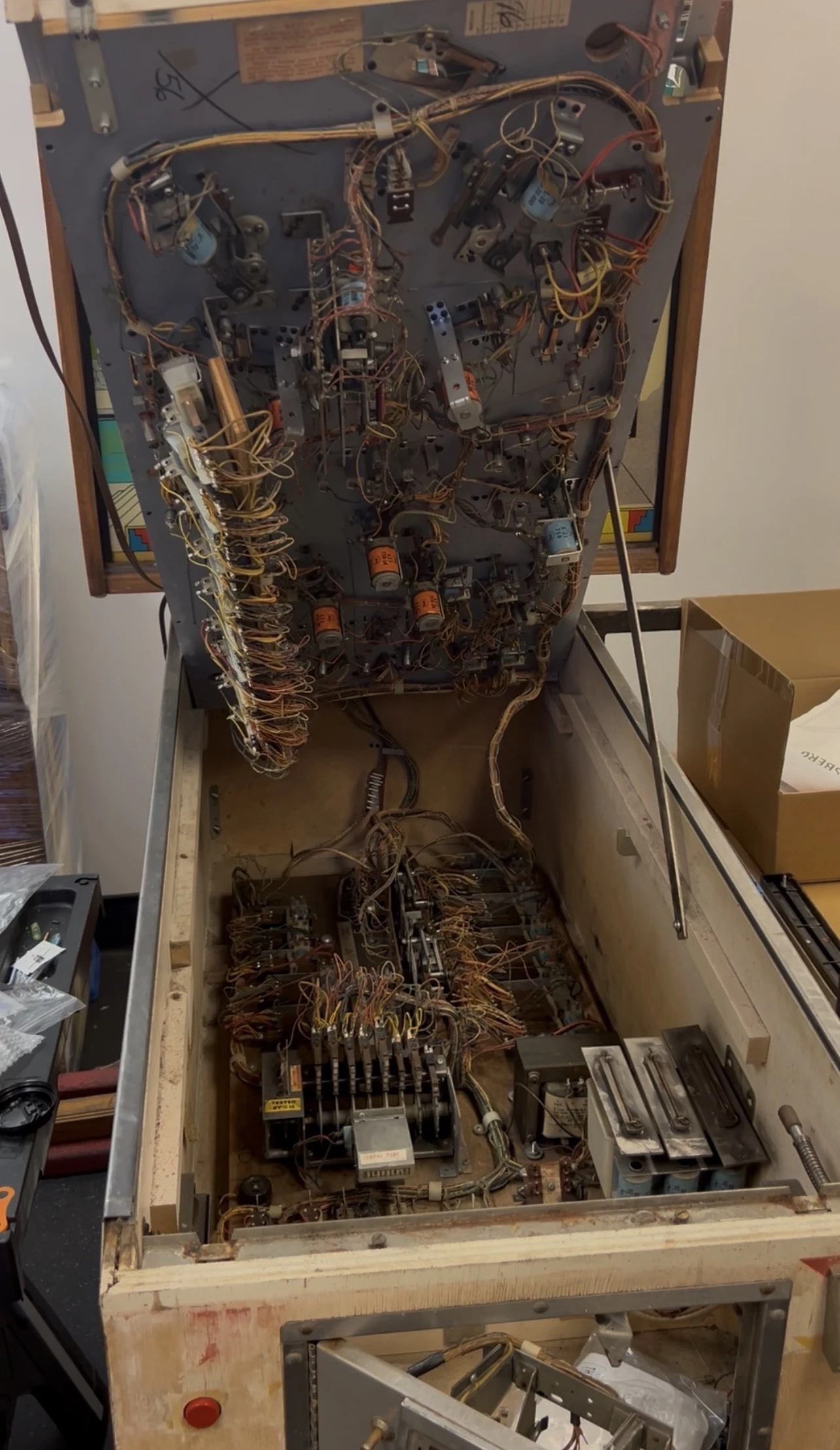 The underbelly of a vintage pinball machine
