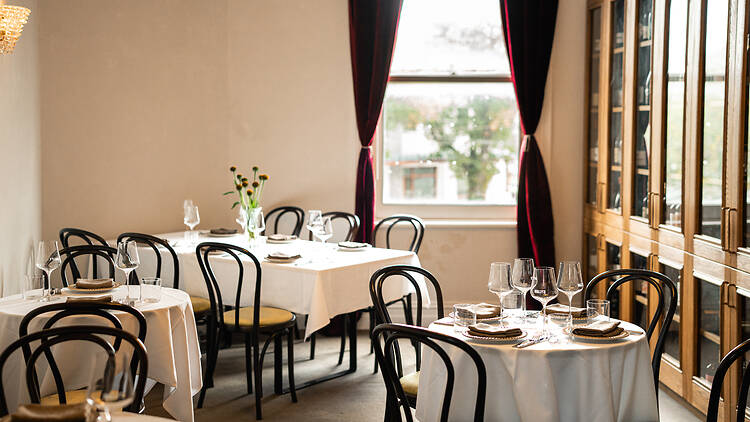 bentwood chairs and tablecloths on tables  – interiors of Wally's Albert Park