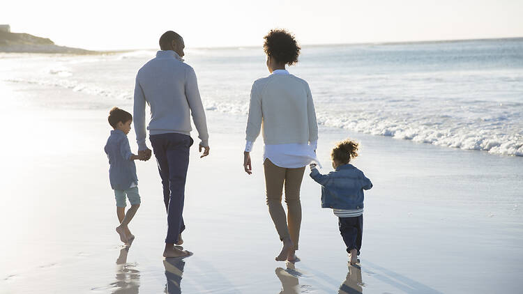 Family on a beach walk Happy family having fun on beach