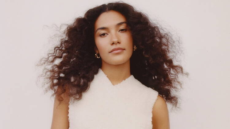 A medium close-up shot of a woman in white