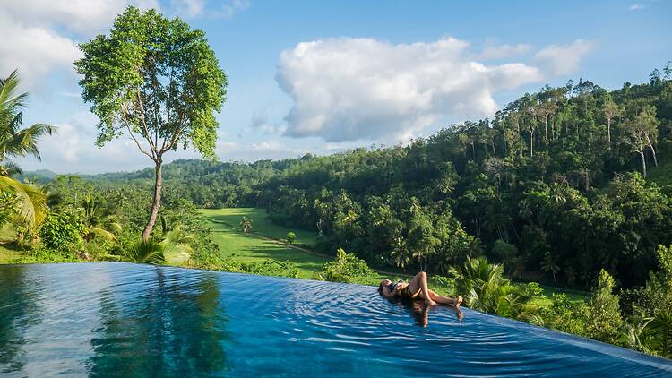 Sri Lanka Beautiful Young Traveler is Relaxing in the Pool Lying on the Edge of the Swimming Pool in a Luxury Villa Nearby Galle, Sri Lanka