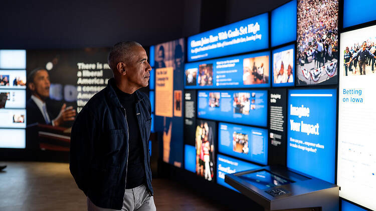 President Barack Obama walks through the Obama Presidential Center Museum.