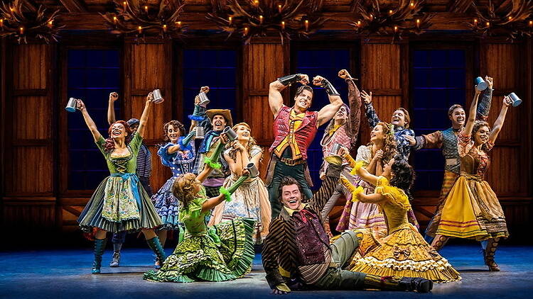 A wide shot of a group of actors performing onstage