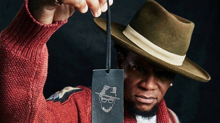 A medium close-up shot of a man holding a black cardboard tag A medium close-up shot of a man holding a black cardboard tag