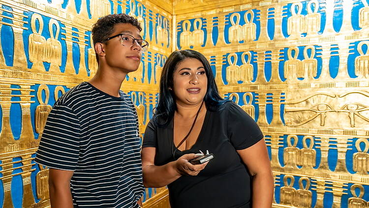 A close-up of two people at a museum. A close-up of two people at a museum.