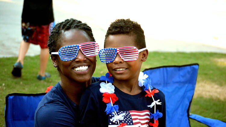A close-up of two people wearing glasses with an American flag design.