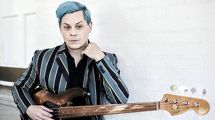 A close-up of Jack White holding a guitar. A close-up of Jack White holding a guitar.