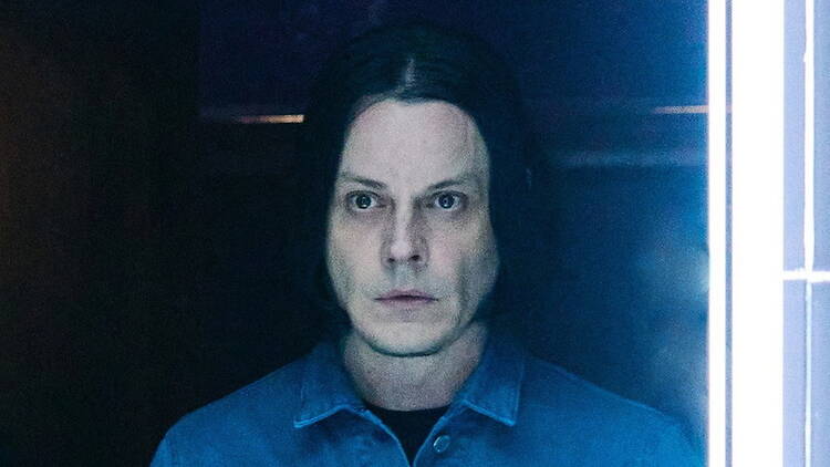 Close-up of a person staring ahead in a dimly lit room with neon lights Close-up of a person staring ahead in a dimly lit room with neon lights