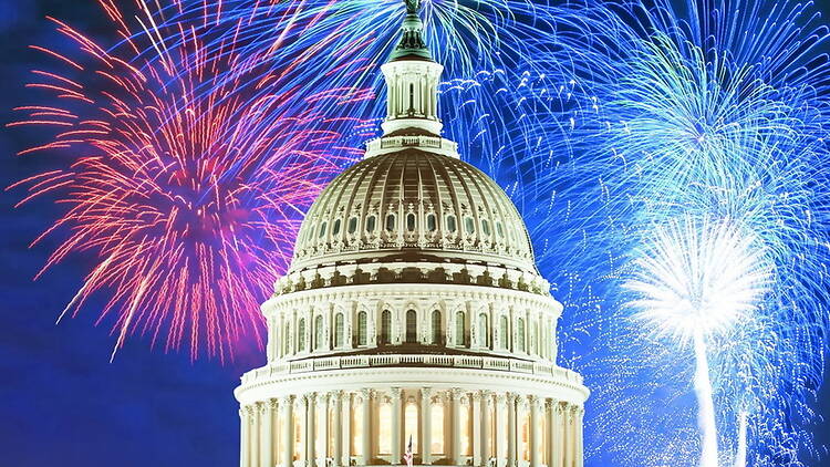 A wide shot of a dome of a building against a backdrop of colorful fireworks A wide shot of a dome of a building against a backdrop of colorful fireworks