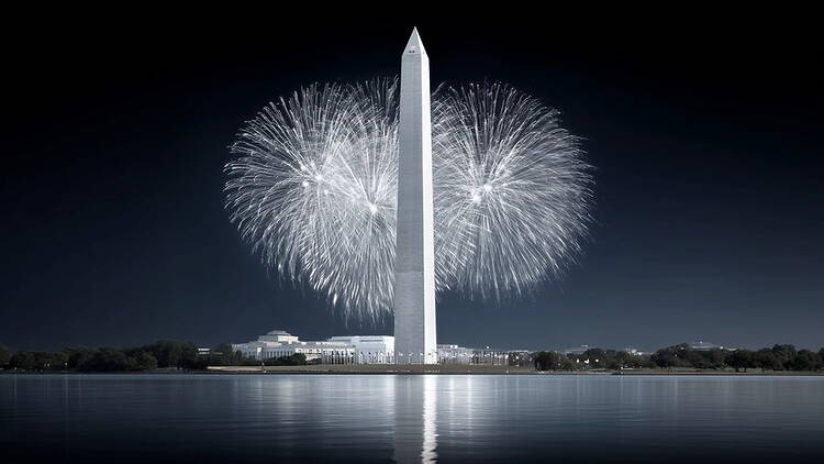 Wide shot of a tall monument with fireworks bursting directly behind it Wide shot of a tall monument with fireworks bursting directly behind it