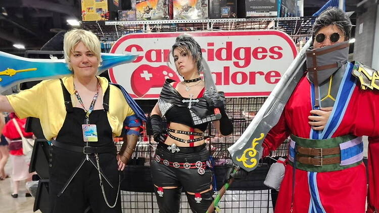 Wide shot of three cosplayers posing Wide shot of three cosplayers posing