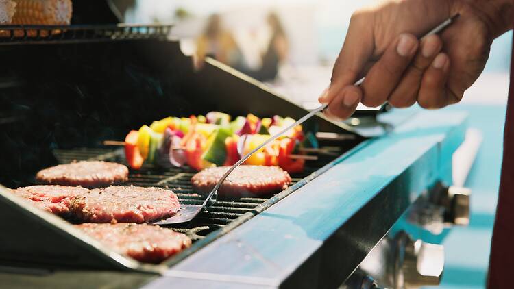 Burgers and kebabs on a barbecue grill