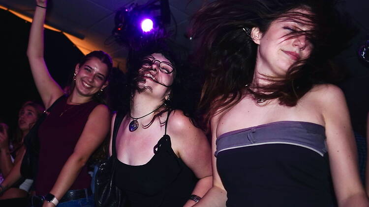 A close-up of three women dancing indoors. A close-up of three women dancing indoors.