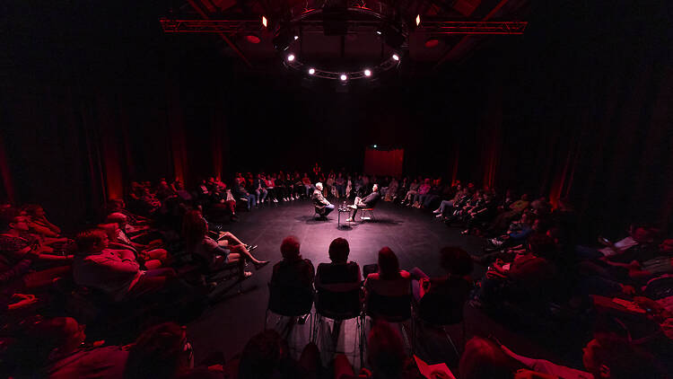 Festival of Dangerous Ideas People sitting in a circle in a dark room