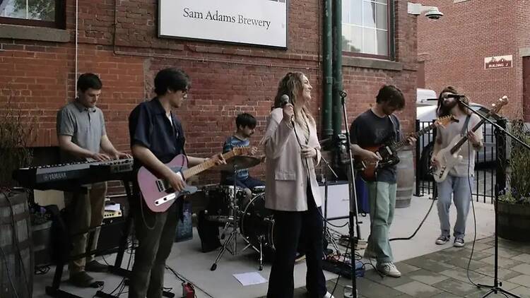 A wide shot of a band performing outdoors. A wide shot of a band performing outdoors.