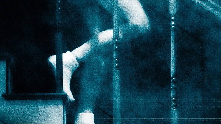 A close-up of feet walking down a staircase. A close-up of feet walking down a staircase.