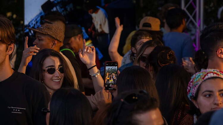 A close-up of people gathering at an outdoor event. A close-up of people gathering at an outdoor event.