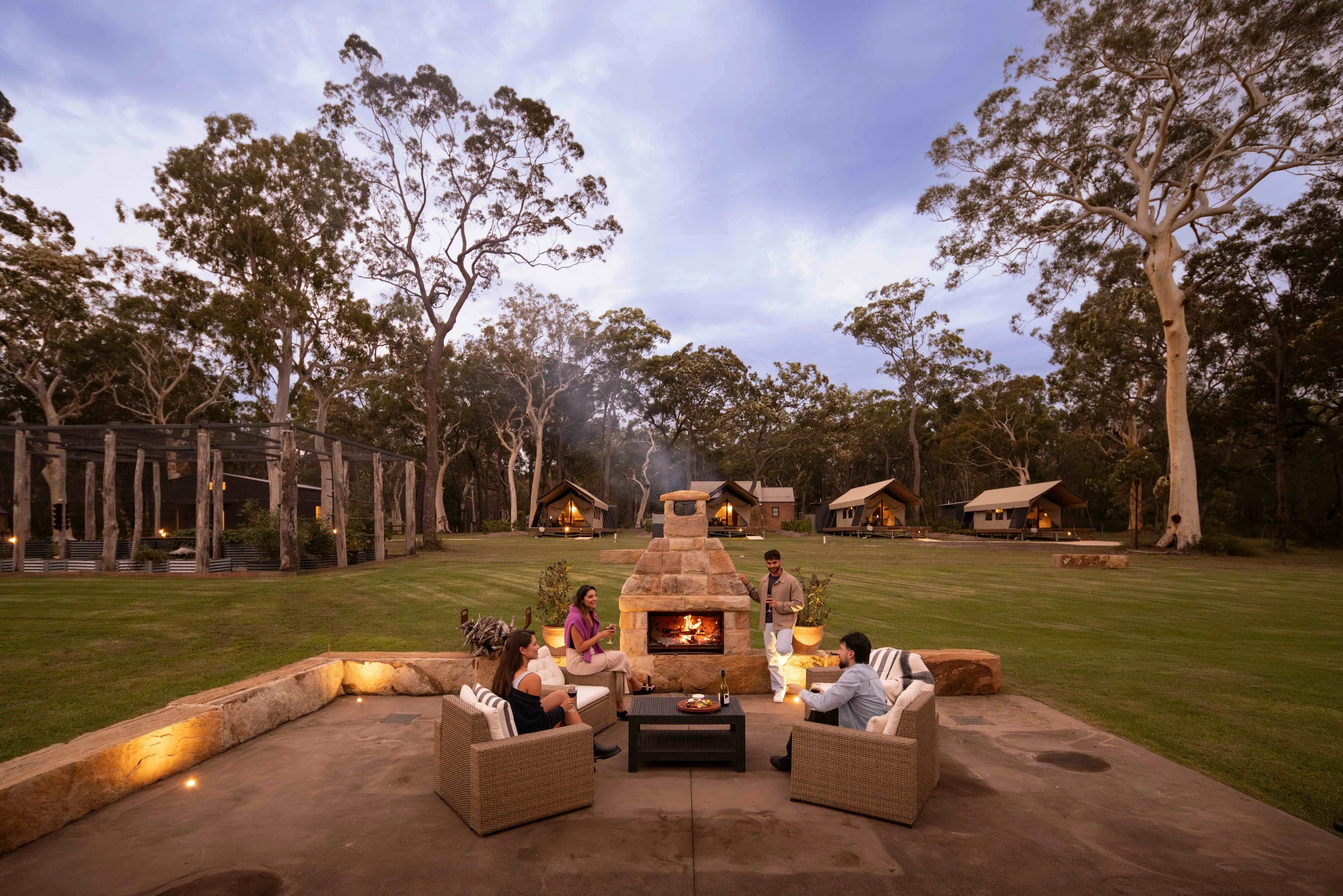 Friends cozy up in front of the fire at Bay and Bush, Jervis Bay