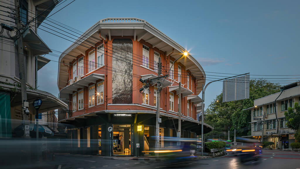 The orange curved facade of The Corner House in Talat Noi