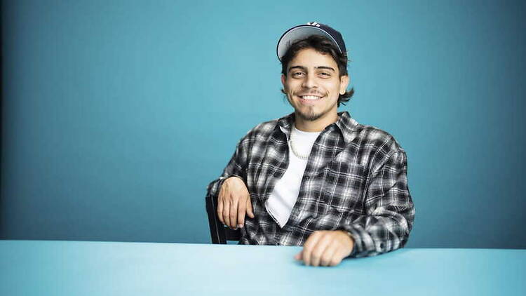 A close-up of a person smiling while seated at a table A close-up of a person smiling while seated at a table