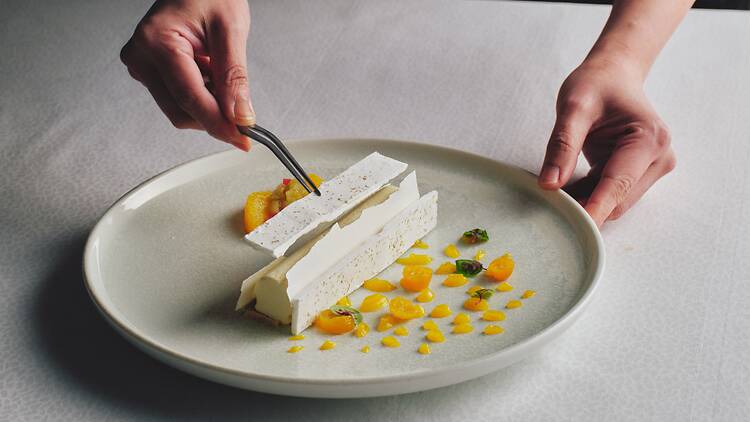 Altitude at Shangri La Sydney a chef decorating a plate