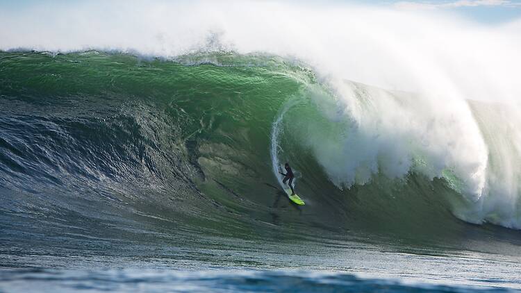 A surfer rides the wall of water at Dungeons, off Cape Town. A surfer rides the wall of water at Dungeons, off Cape Town.