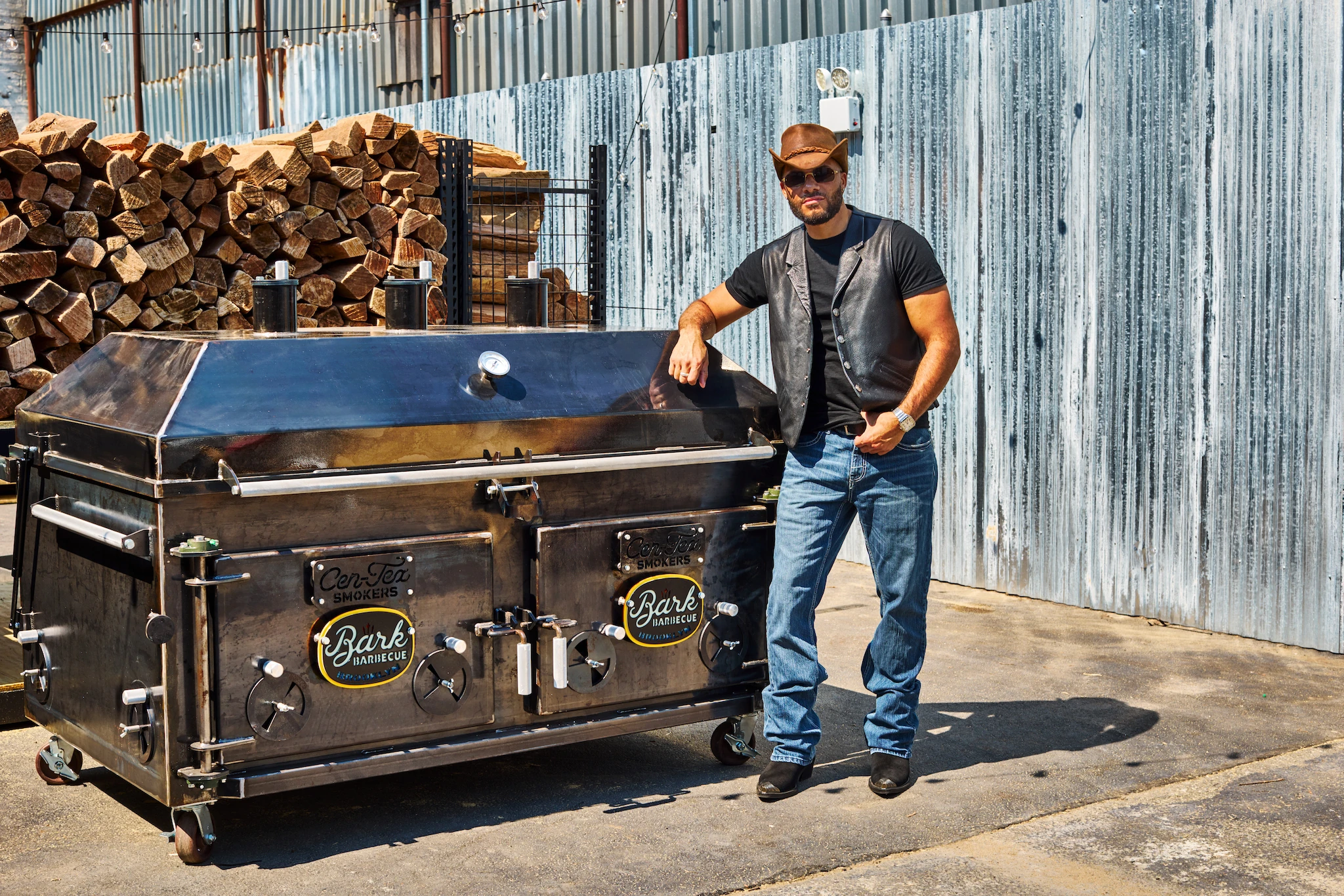 Ruben Santana of Bark Barbecue standing by a smoker