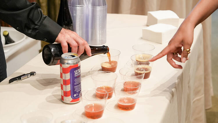 TALEA Beer Co A person pointing to beers poured on a table
