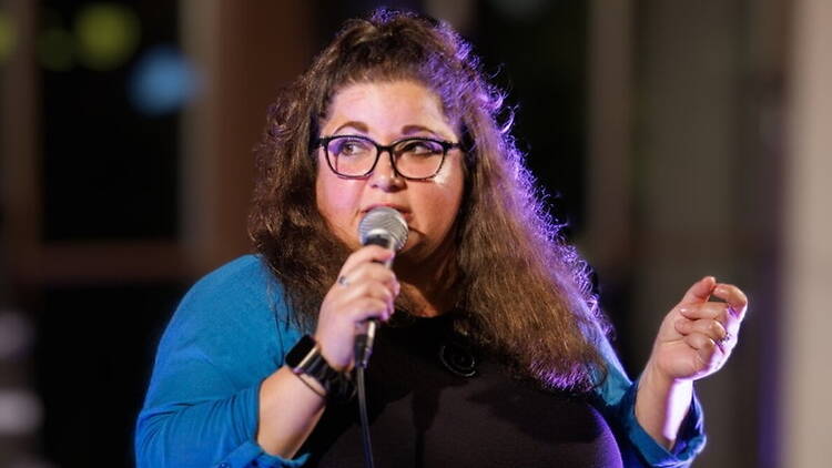 Medium close-up of a person speaking to a microphone. Medium close-up of a person speaking to a microphone.