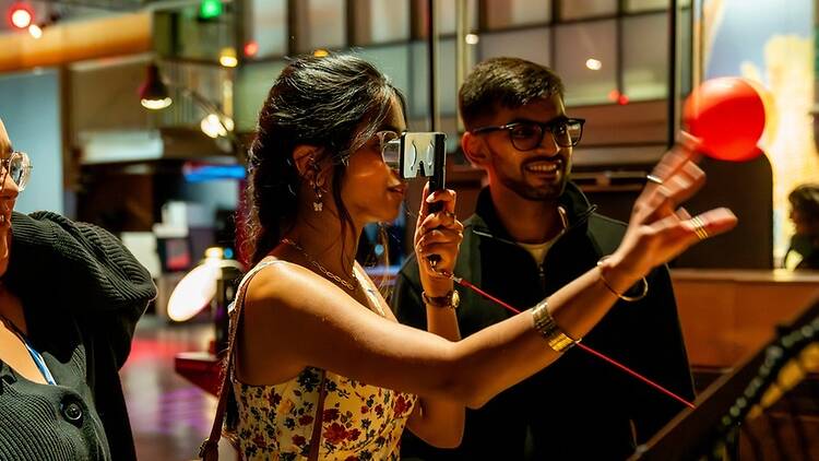 Medium shot of a person interacting with an exhibit Medium shot of a person interacting with an exhibit