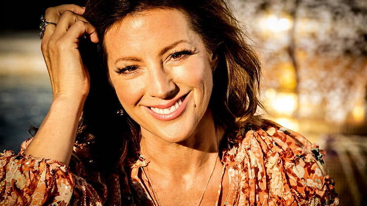 Close-up person smiling outdoors in warm sunlight. Close-up person smiling outdoors in warm sunlight.