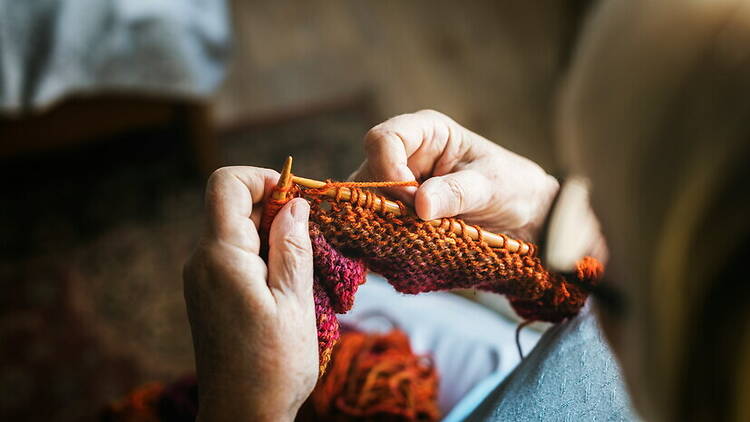 Close-up view of a person's hands knitting Close-up view of a person's hands knitting
