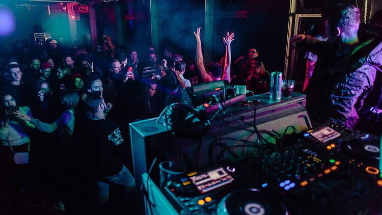 Wide shot view of a dj performing to an audience Wide shot view of a dj performing to an audience