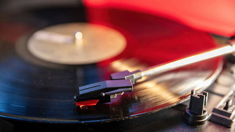 Close-up view of a vinyl record spinning in a turntable. Close-up view of a vinyl record spinning in a turntable.
