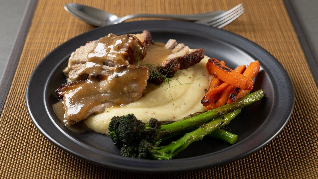 Pork belly slowly braised in fennel and onion, with wholegrain mustard mash, orange-glazed carrots, charred tenderstem broccoli and fennel jus