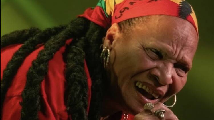 A close-up of a performer singing. A close-up of a performer singing.