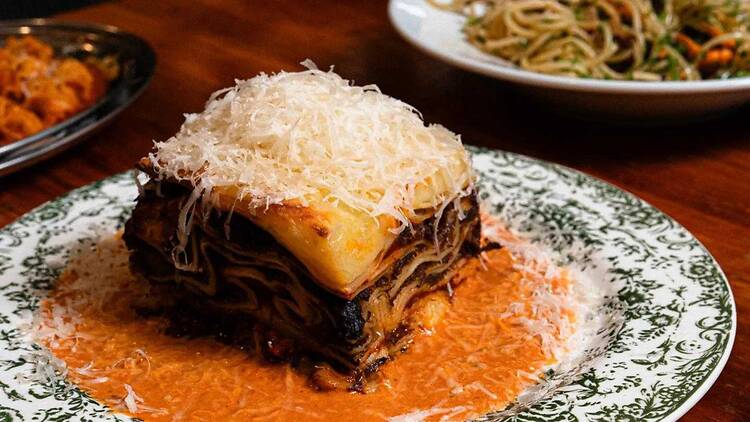 A lasagne in a vodka sauce, with shaved parmesan on top