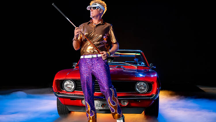 The Hawk - Season 1. (L to R) Will Ferrell as Lonnie in Episode 103 of The Hawk. Cr. Colleen E Hayes/Netflix © 2026 Will Ferrell as Lonnie in Episode 103 of The Hawk holding a golf club in front of a sports car.