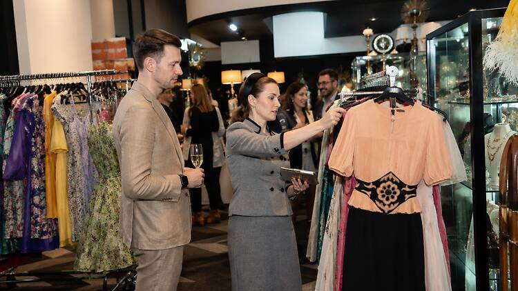 The Melbourne Fair people browsing racks of clothes