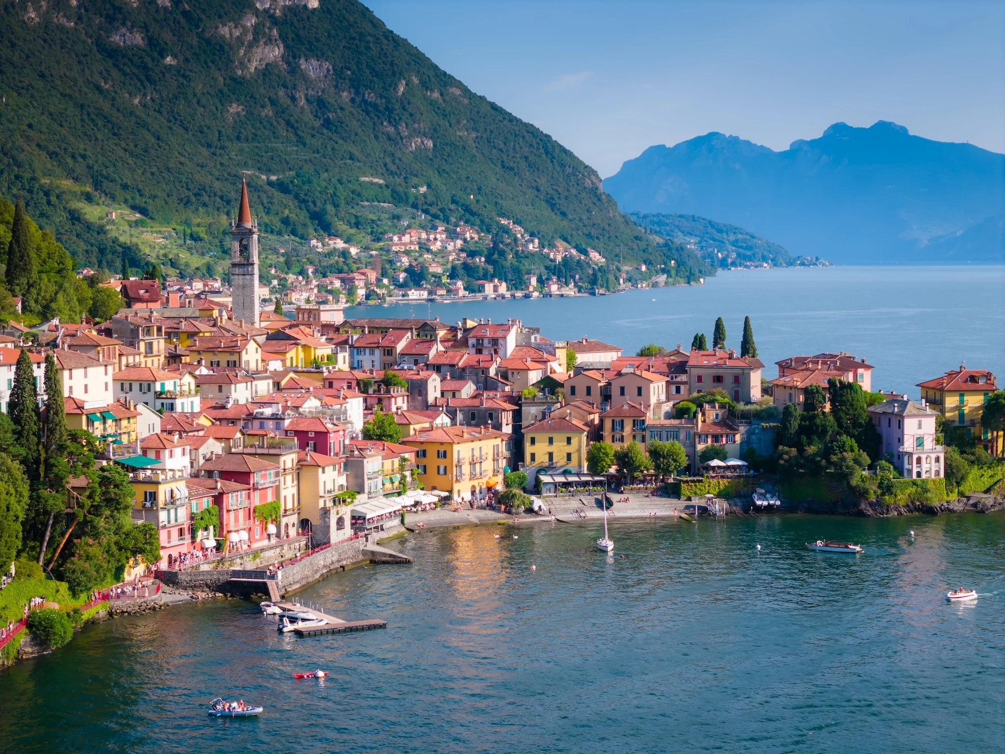 Aerial panoramic drone view of beautiful town with colorful houses surrounded by mountains