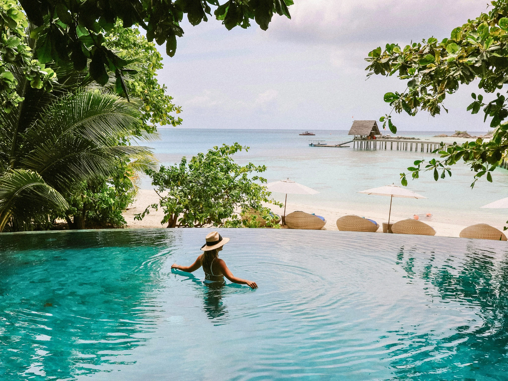 Girl in pool by beach