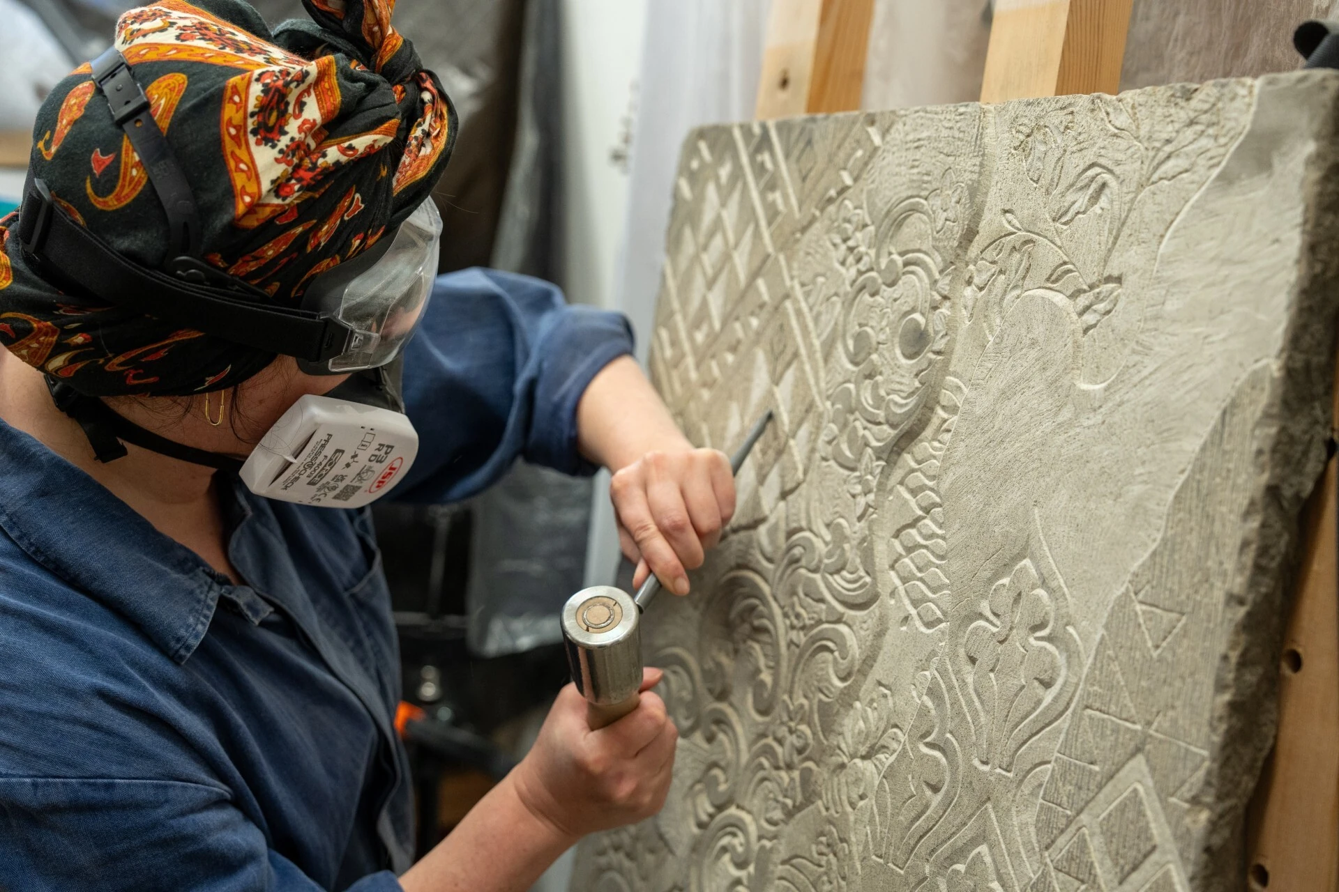 Jo Grogan carving a tile for the House of Bandits caf&eacute;