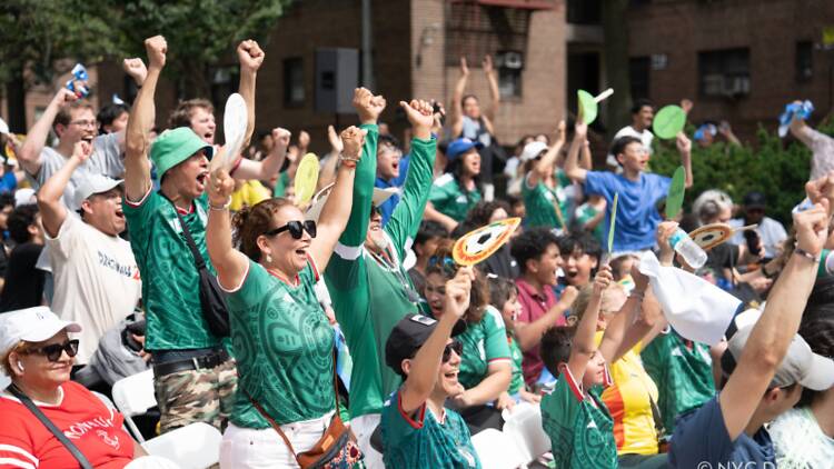 New Yorkers watch the World Cup at an NYC DOT Watch Party at Paseo Park in Jackson Heights, Queens. 
