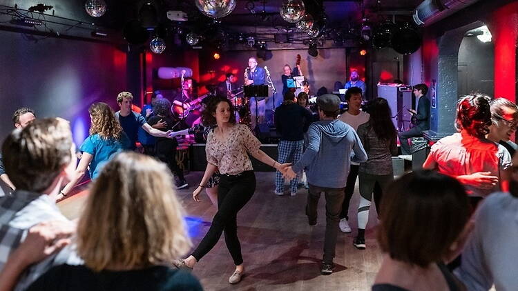 Wide shot view of people dancing to a live band. Wide shot view of people dancing to a live band.