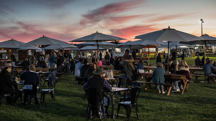 Horizontal Festival An outdoor festival with tables and shades