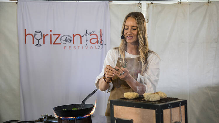 Horizontal Festival A food presentation by a woman wearing a mic