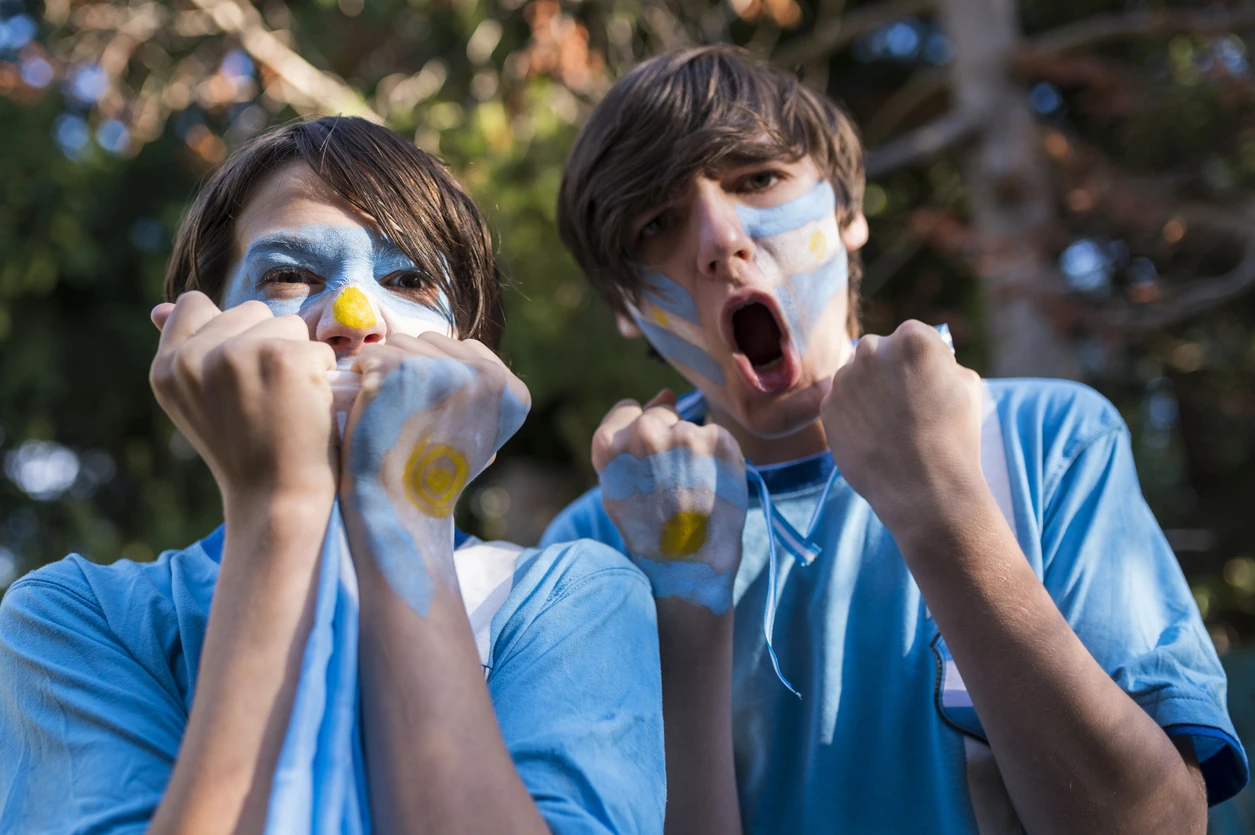Fans of the Argentine soccer team, painted with the colors of Argentina cheering in the World Cup.
