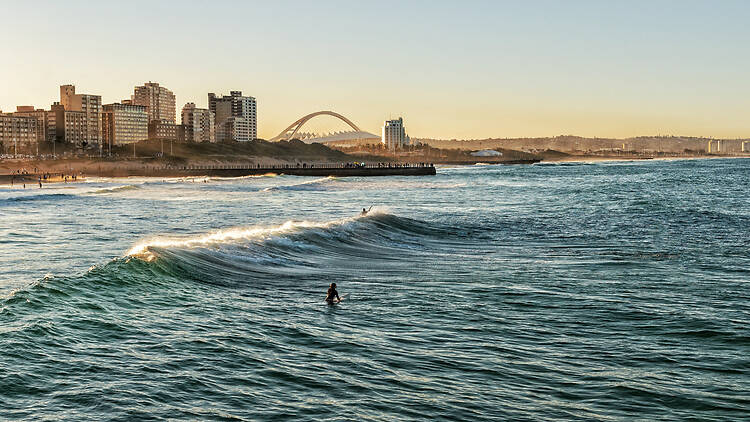 Surfers Enjoying the Waves During Sunset Duban Beach Surfers
