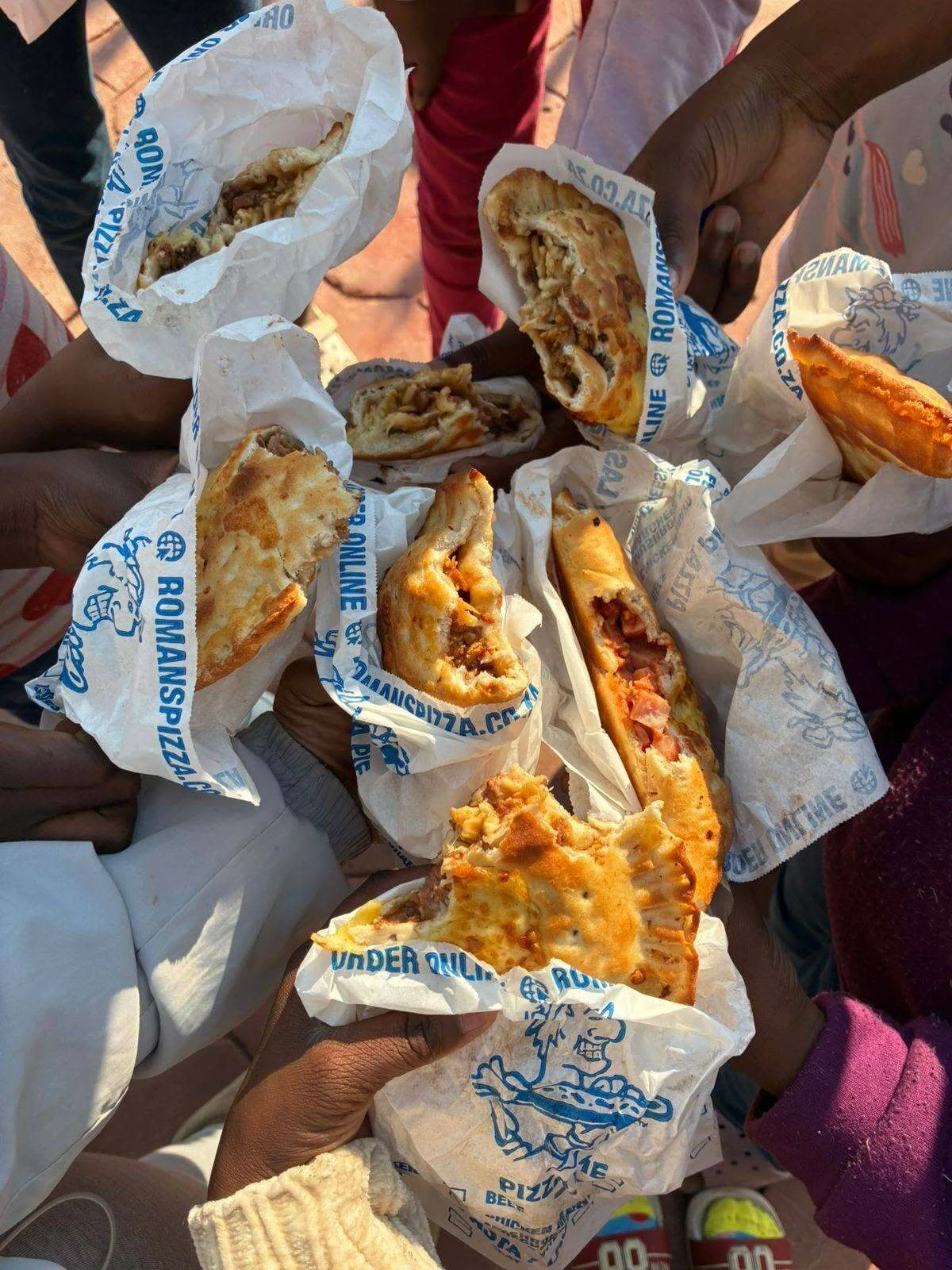 Children eating pie at Jehovah Jirah Orphanage Centre