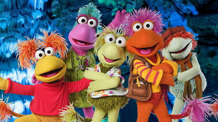 A wide shot of colorful puppet characters posing in a fantasy setting. A wide shot of colorful puppet characters posing in a fantasy setting.